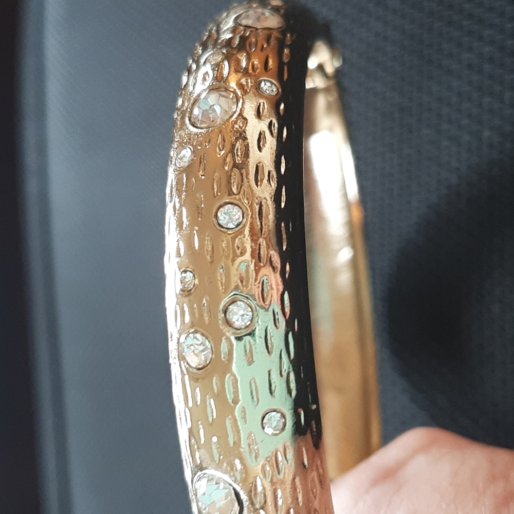 Gold tone and rhinestone hinged bangle bracelet